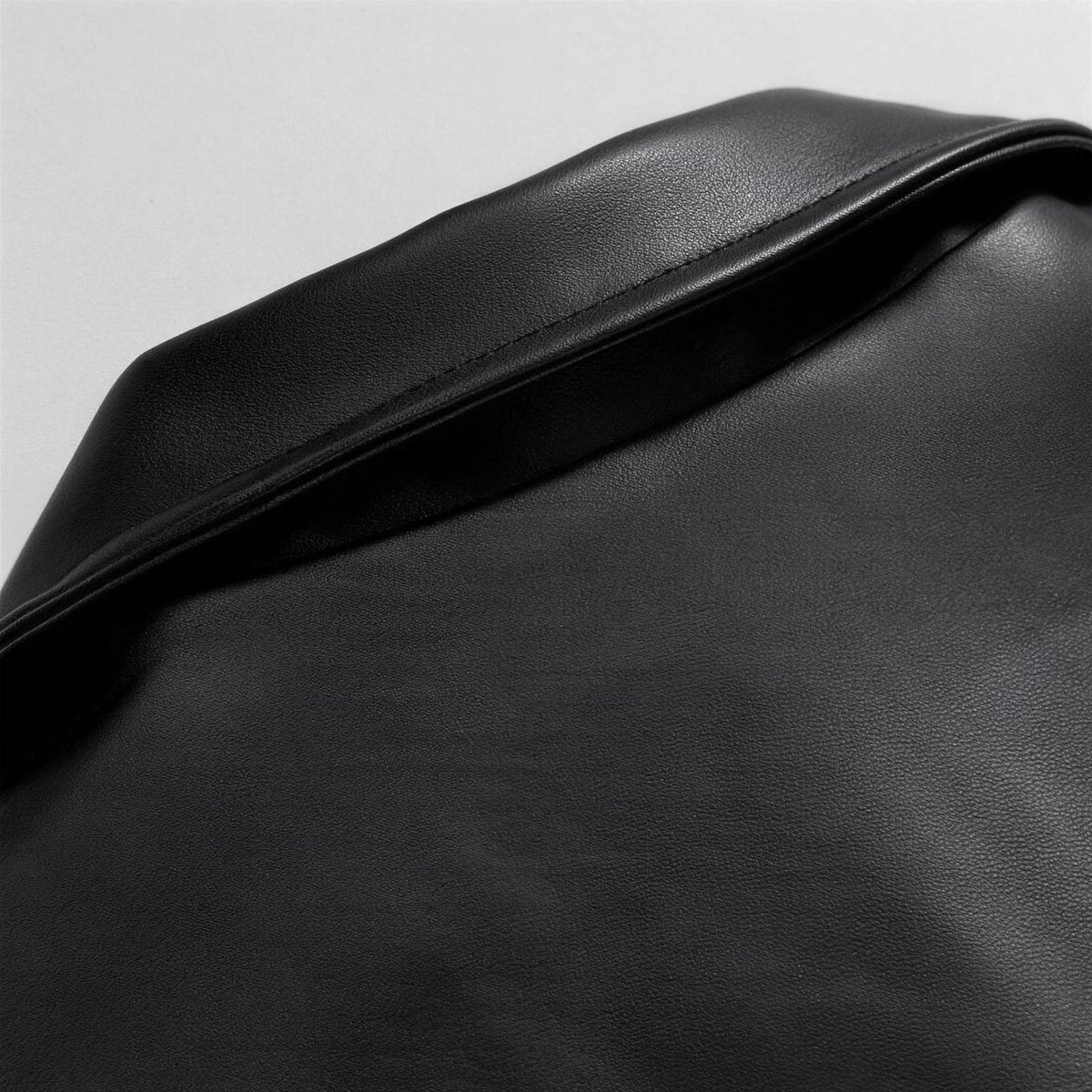 Oversized leather bomber jacket, detail of the collar and shoulder