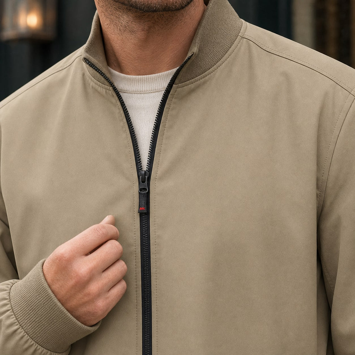 Beige jacket, close up of the ribbed stand collar and zip