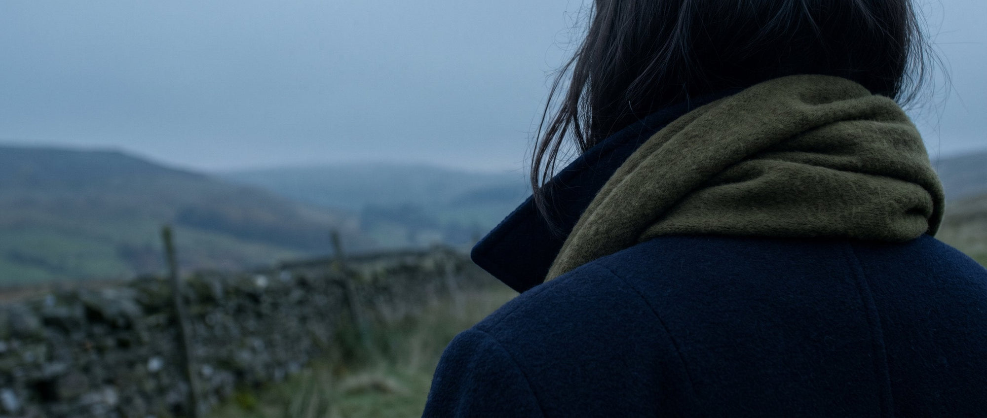 Close-up of a coat collar turned up against the wind in the British hills