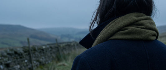 Close-up of a coat collar turned up against the wind in the British hills