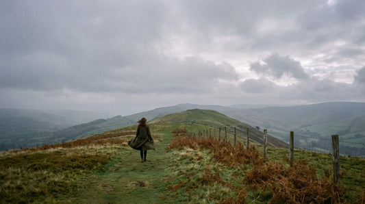 Walker in layered outerwear on a ridge path
