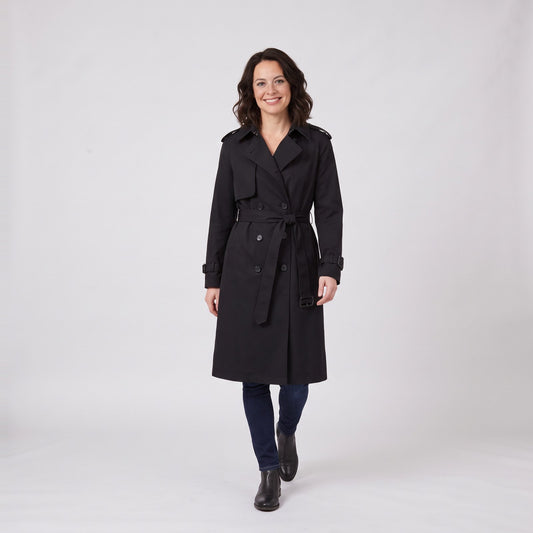 Woman wearing a black belted double breasted long trench coat