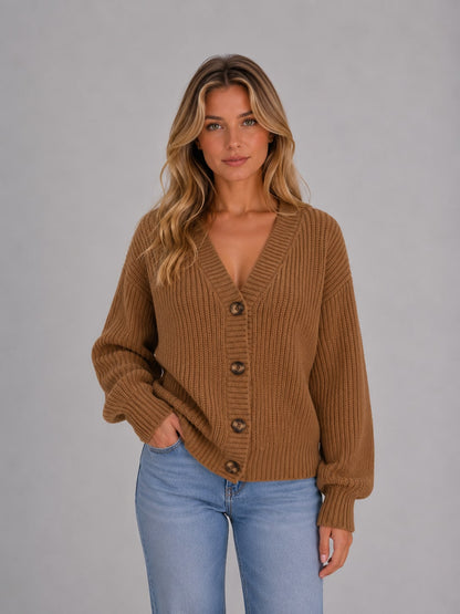 Model wearing the camel chunky knit cardigan buttoned up with jeans