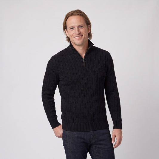 Man wearing the classic cable knit half zip jumper with zip collar