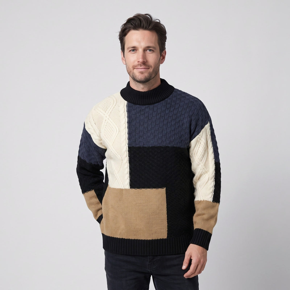Man wearing a black colour block cable knit pullover with ribbed high neck