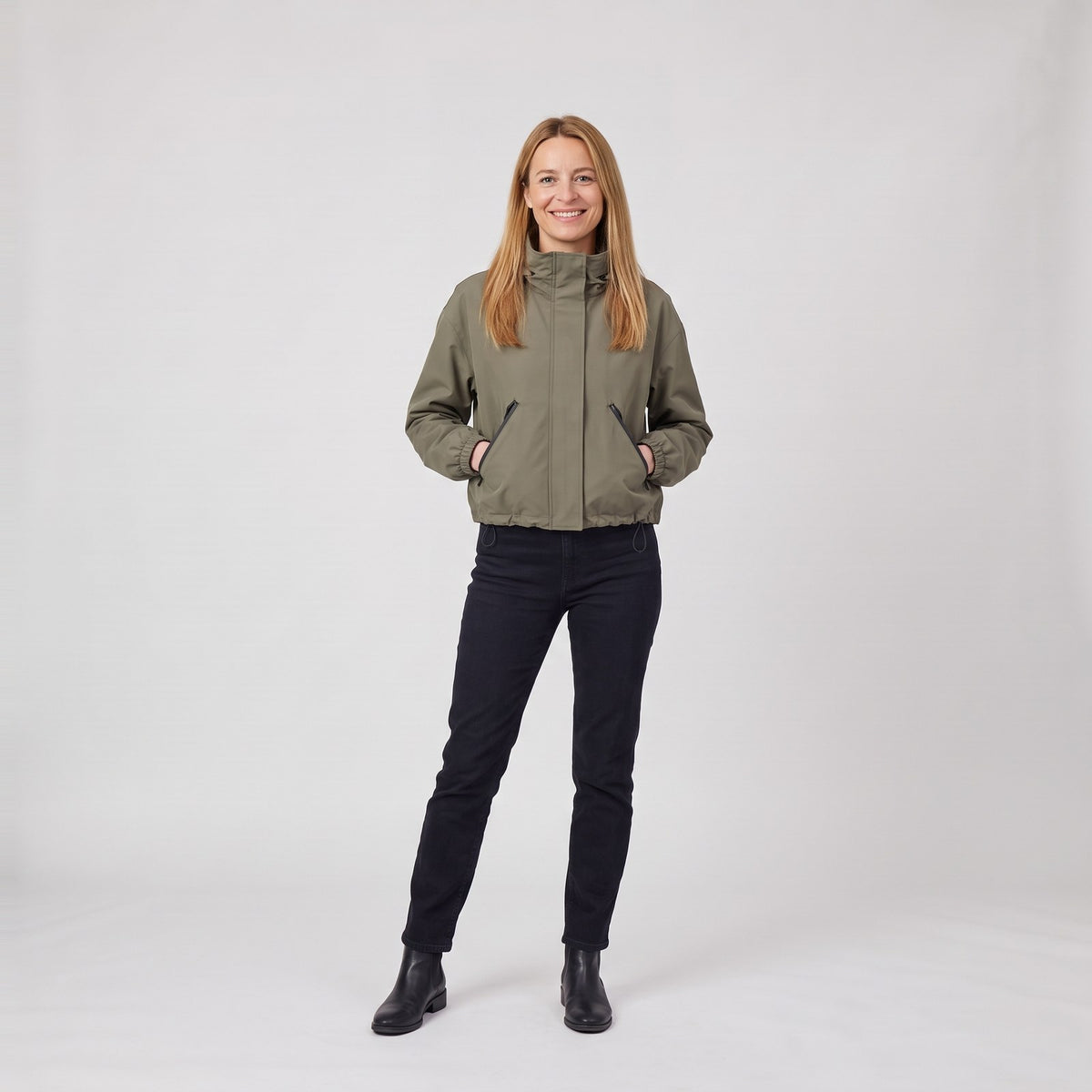 Woman wearing the cropped boxy hooded rain jacket with slanted zip pockets
