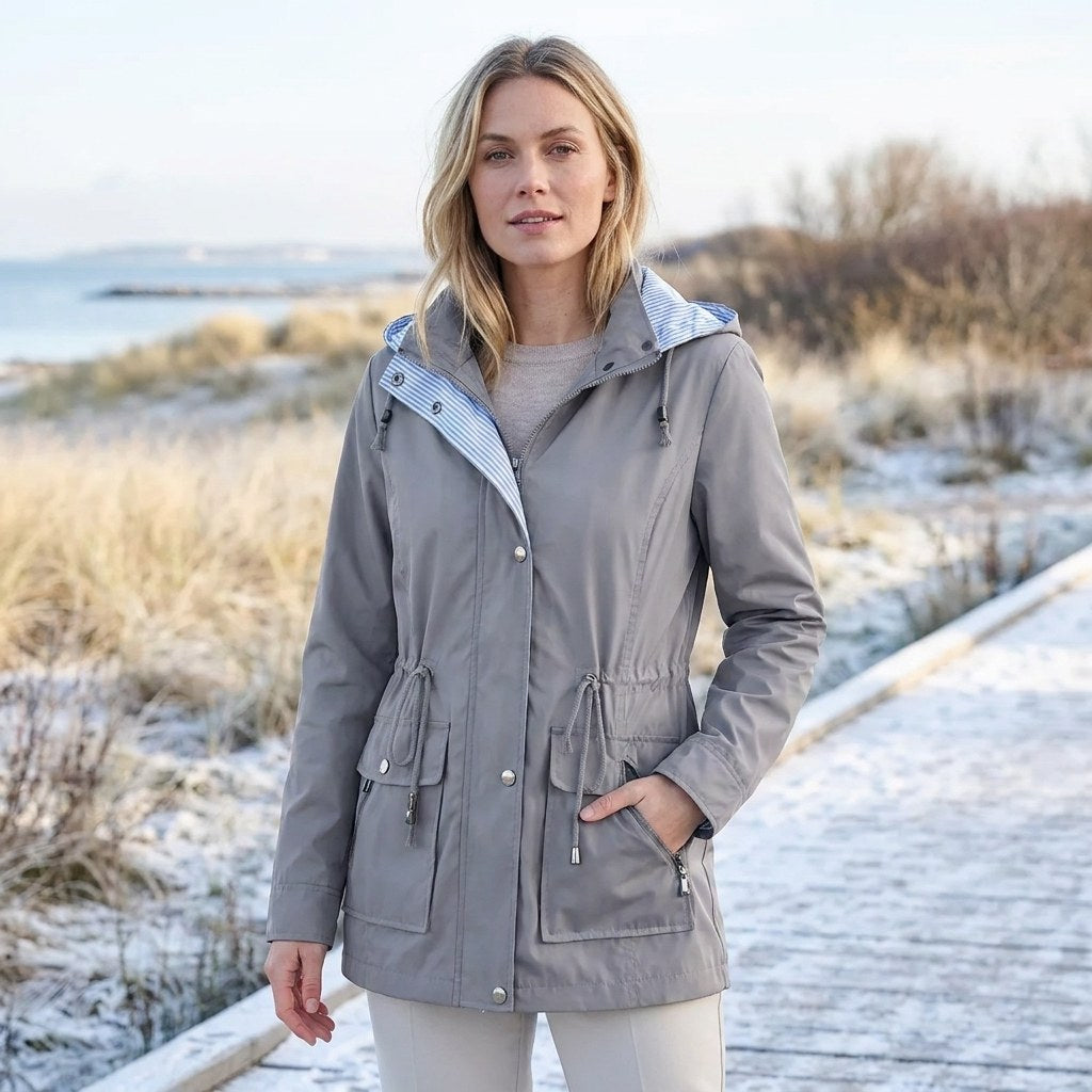 Grey drawstring waist hooded parka worn outdoors