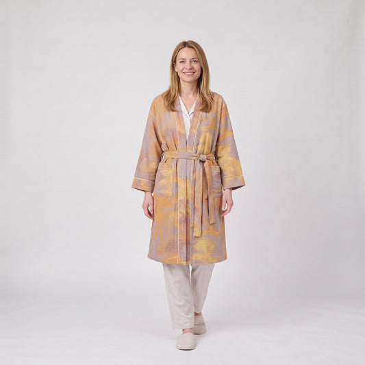 Woman wearing the kimono style cotton dressing gown with botanical print