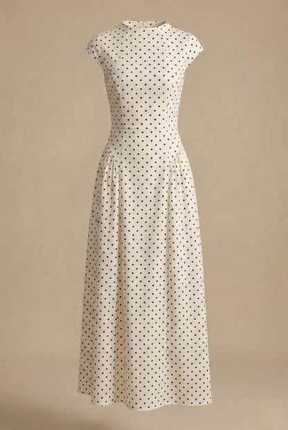 Polka dot maxi dress shown on its own against a beige background