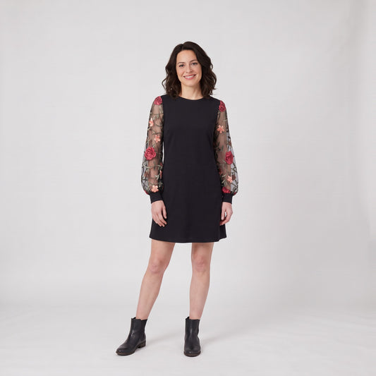 Woman wearing the elegant shift dress with sheer floral embroidered balloon sleeves