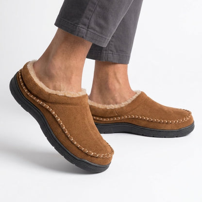 Brown fleece lined slippers worn on feet