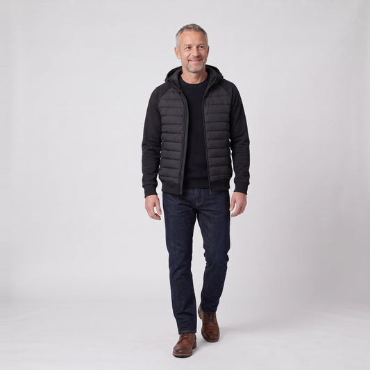 Man wearing the hybrid hooded puffer jacket with softshell sleeves