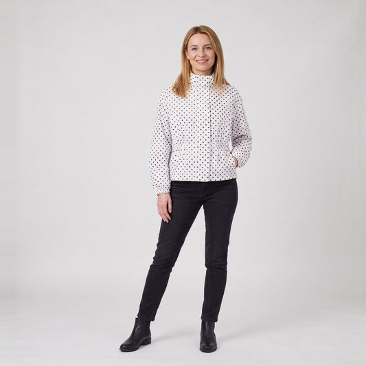 Woman wearing the lightweight polka dot rain jacket with drawstring waist