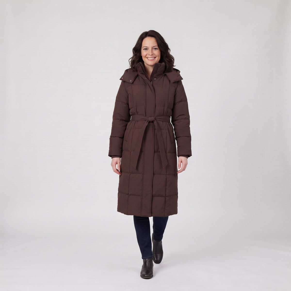 Woman wearing the long belted quilted puffer coat with high collar