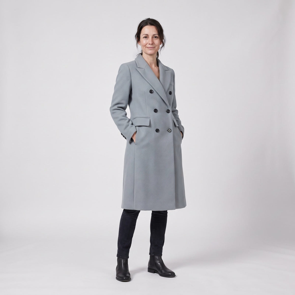 Long double breasted wool winter coat in grey with notch lapels, worn by a model