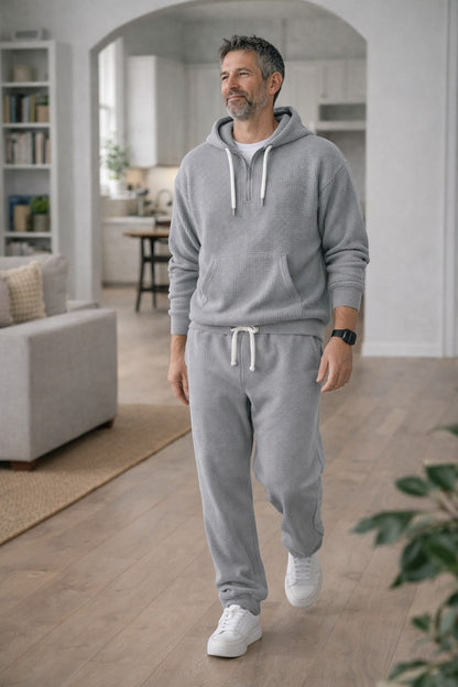 Grey half zip hoodie and joggers worn indoors