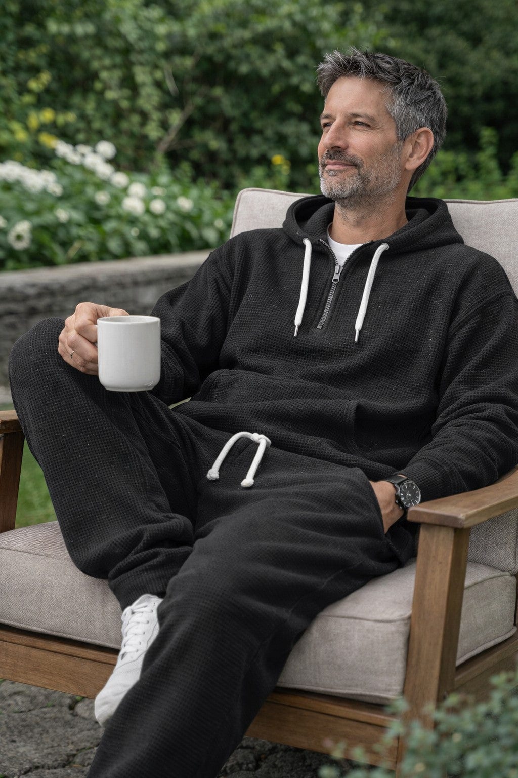 Black half zip hoodie and joggers worn outdoors
