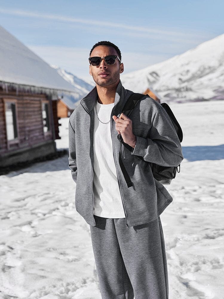 Grey zip jacket worn open over a white tee