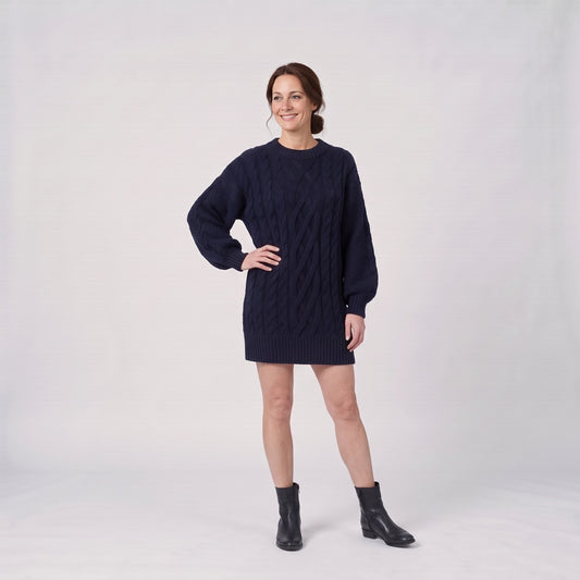 Woman wearing the oversized chunky cable knit jumper dress with balloon sleeves
