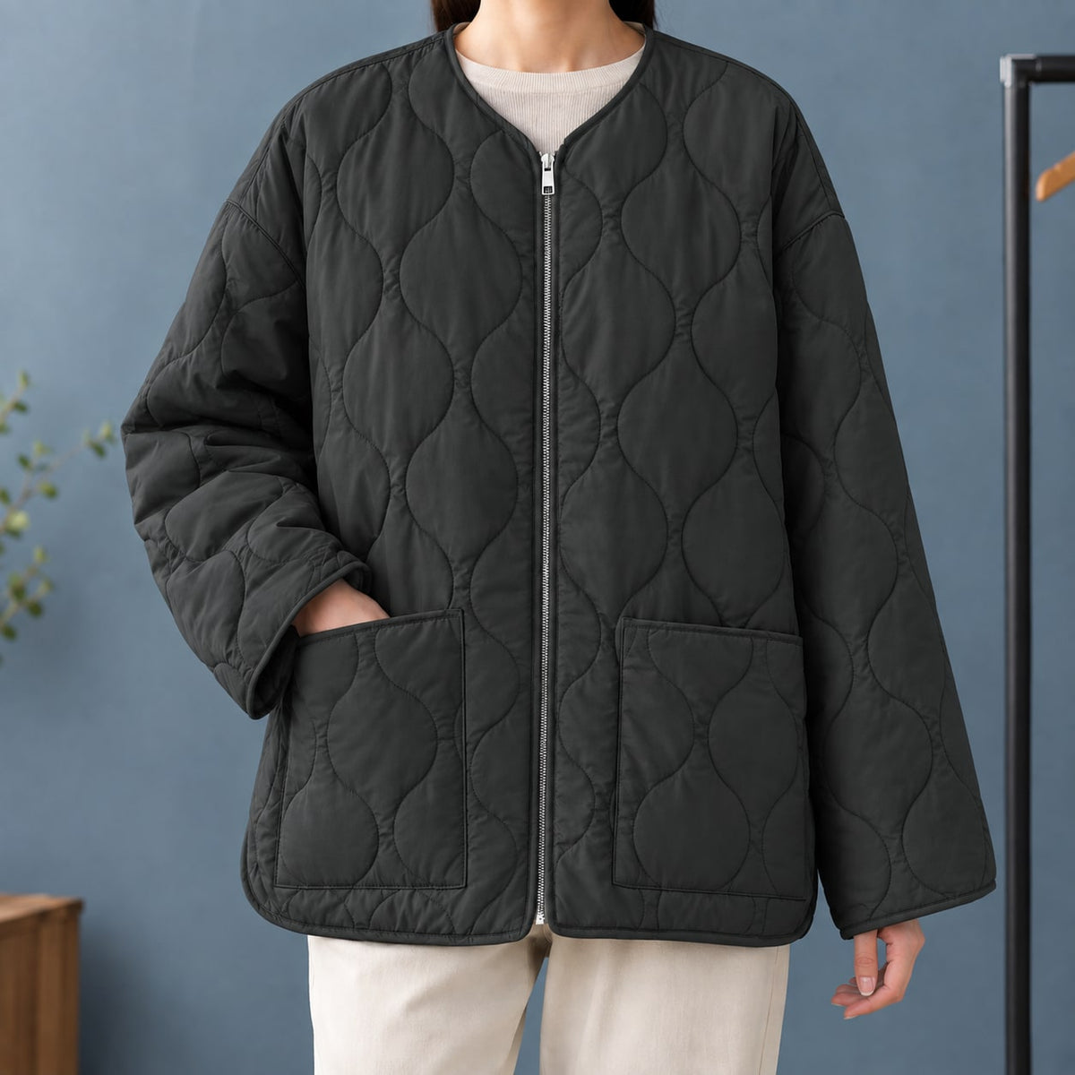 Black quilted collarless zip jacket with patch pockets