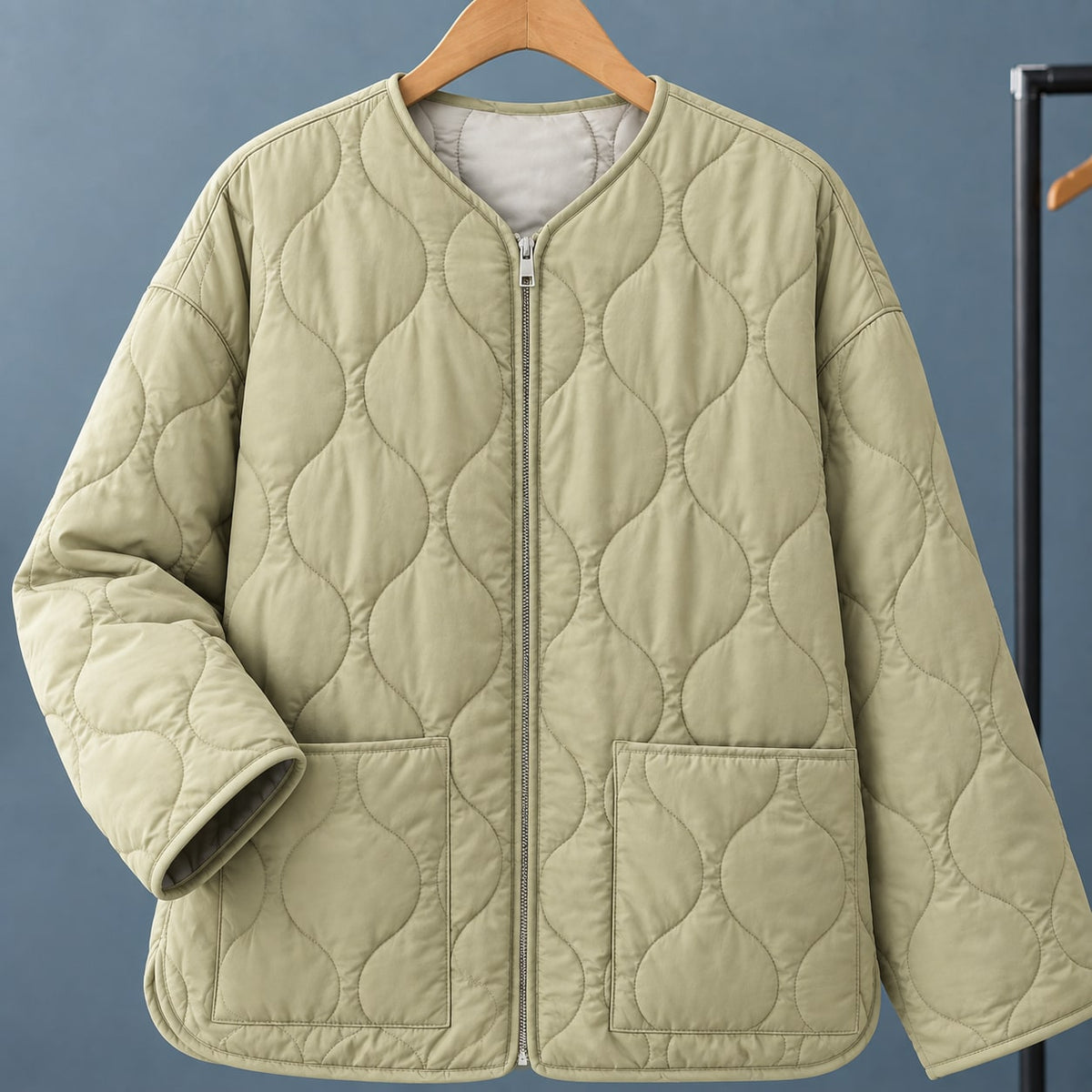 Light green quilted jacket on a hanger