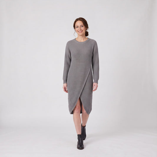 Woman wearing the relaxed ribbed knit midi jumper dress with wrap front hem