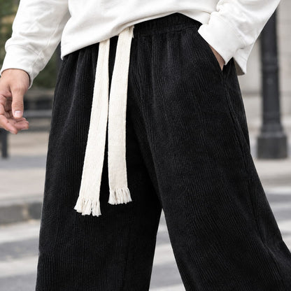 Black trousers, close up of the tasselled drawstring waist
