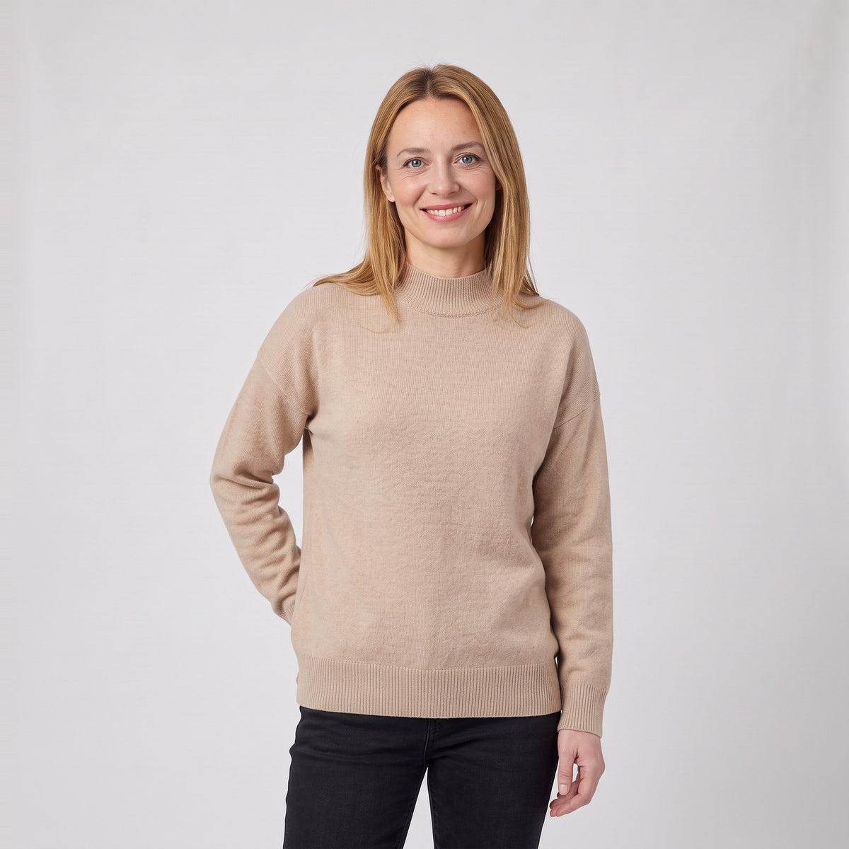Woman wearing the soft mock neck knit jumper with ribbed cuffs