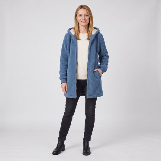 Woman wearing the mid length teddy fleece hooded zip coat with sherpa lined hood