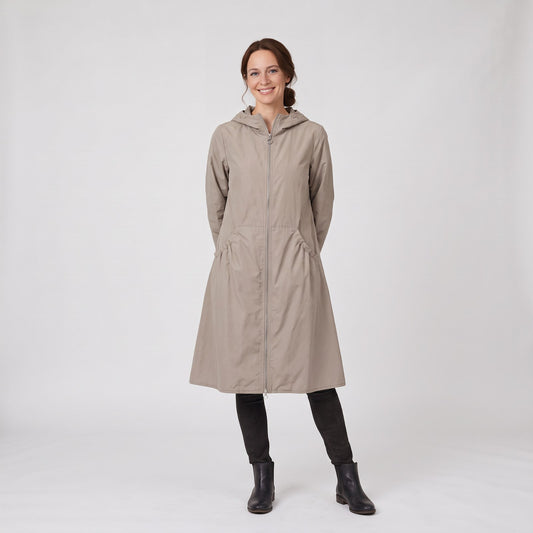 Woman wearing the waterproof long hooded A-line rain coat with full zip